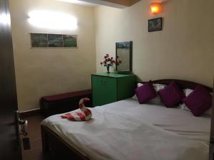 Tempat tidur dalam kamar di Hotel Jignam