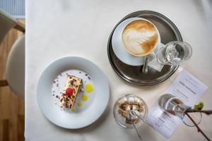 een tafel met een bord eten en een kopje koffie bij Hotel Radun in Luhačovice