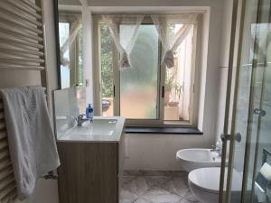 a bathroom with a sink and a mirror and a window at Il Girasole in Gaeta