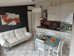 a living room with a white couch and a table at Il Girasole in Gaeta