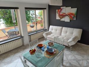 a living room with a table and a couch at Il Girasole in Gaeta