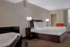 Tempat tidur dalam kamar di Ramada Plaza by Wyndham Calgary Downtown