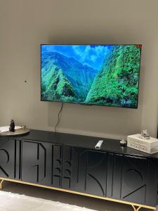 a flat screen tv on top of a black entertainment center at The Opus Luxury Residences in Lahore