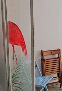 una pintura de un paraguas rojo junto a una silla en Estudio 609 Playa Las Canteras doble, en Las Palmas de Gran Canaria