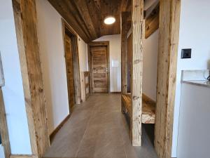 a hallway in a house with wooden beams at Magnifique attique avec vue sur le lac de la Moubra in Crans-Montana