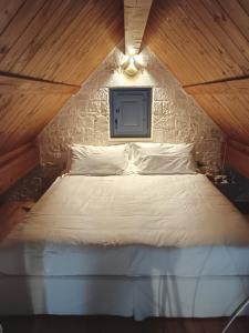 a bedroom with a white bed in a attic at Borgofreddo Luxury Suite in Monopoli