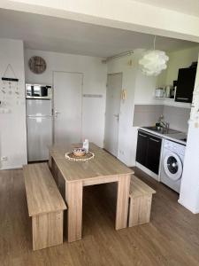 Il comprend un salon avec une table et une cuisine. dans l'établissement Appartement port dienville, à Dienville