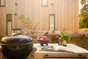 een grill en een fruitschaal op een tafel bij Dutchen Zeegser Duinen Villalodges in Zeegse