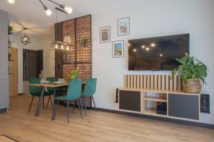 comedor con mesa y TV en la pared en Apartament Terenia, en Puck