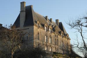 an old building with a chimney on top of it at Chateau de Courseulles in Courseulles-sur-Mer