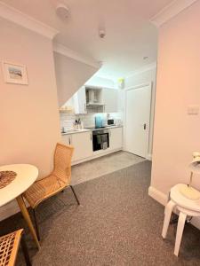 uma cozinha com mesa e cadeiras num quarto em Bournemouth Beach Apartment em Bournemouth