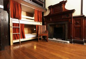 a room with two bunk beds and a fireplace at Palmers Lodge Swiss Cottage in London