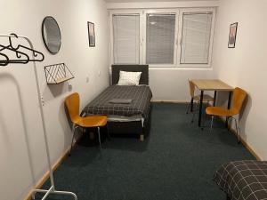 a room with a bed and a table and chairs at Warszawa Zachodnia in Warsaw