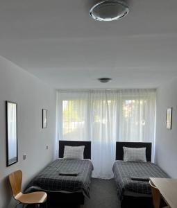 two beds in a room with a window at Warszawa Zachodnia in Warsaw