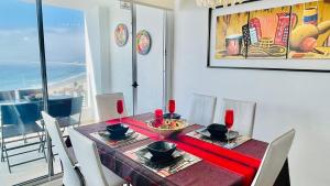 a dining room with a table with a view of the ocean at La Choza VIP Roja in Coquimbo