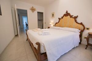 a bedroom with a large bed with towels on it at Casa di Anna in Pistoia