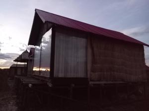 an old building with curtains on the side of it at Q'OTA TAYPY LODGE in Puno