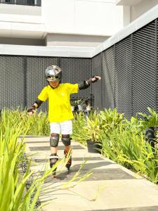 a young boy in a yellow shirt is on skis at Citadines Sudirman Jakarta in Jakarta