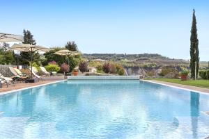 una gran piscina de agua azul en I Sicomori - Seme di Carota - Glamping e appartamenti con piscina a Saturnia, en Saturnia