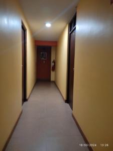 a hallway with two doors and a hallwayngthngthngthngthngthngthngthngth at ANDENES DEL TITICACA in Puno