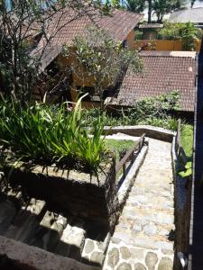 a garden with a stone path and plants at Pousada Éden in Angra dos Reis