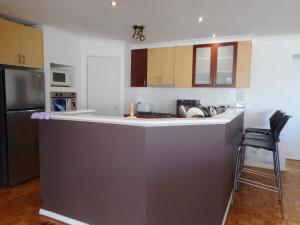 a kitchen with a large island in the middle at A Unique Holiday Home between Avalon Airport and Melbourne CBD in Werribee