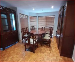 a dining room with a wooden table and chairs at A Unique Holiday Home between Avalon Airport and Melbourne CBD in Werribee