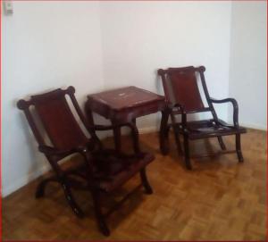 two wooden chairs and a table in a room at A Unique Holiday Home between Avalon Airport and Melbourne CBD in Werribee