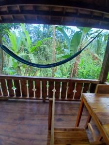 a view from the porch of a house with a hammock at MY HOME tetebatu in Tetebatu