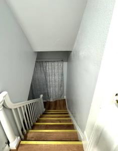 a staircase in a house with white walls and wooden floors at Getaway at Falls-3 Beds-Slips 6 in Niagara Falls