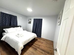 a bedroom with a white bed and blue curtains at Getaway at Falls-3 Beds-Slips 6 in Niagara Falls