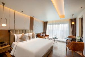 Llit o llits en una habitació de Grand Madurai by GRT Hotels