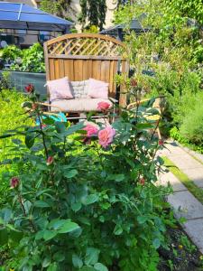 een tuin met een bank en bloemen in een tuin bij Hotel Pension Alte Mühle in Klosterneuburg