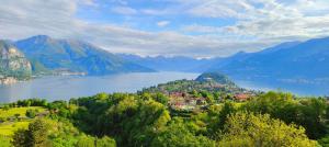 a town on a hill next to a body of water at Hotel Il Perlo in Bellagio