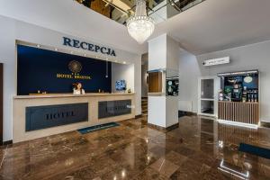 a lobby of a hotel with a ticket counter at Hotel Bristol in Kielce