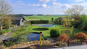 a view of a garden with a trampoline at Bonheur à la campagne in Bastogne