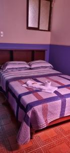 A bed or beds in a room at Hostal Chavin