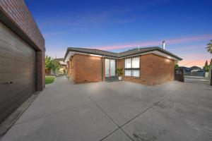 a brick house with a driveway in front of it at Newly Renovated House near Melbourne Airport in Melbourne