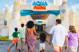 a group of people walking out of an amusement park at El Dorado Casitas Royale Catamarán, Cenote & More Inclusive in Puerto Morelos