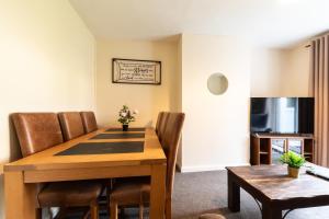 a dining room with a wooden table and chairs at 4 bedrooms house for working Professionals in Southampton