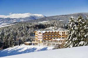 a hotel on top of a snow covered mountain at Hotel Chalet Tianes - Alpine Relax in Castelrotto