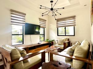 a living room with a couch and a table at Bella Homes 6BR 4Bath near Rotunda in Tagaytay