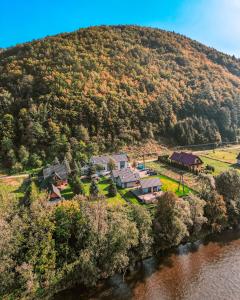 an aerial view of a house on a hill next to a river at Domek szeregowy nr 2 in Tylmanowa