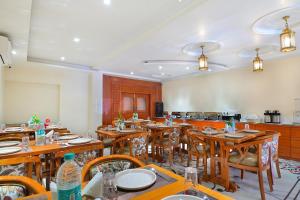 a large dining room with wooden tables and chairs at Trim Boutique Parkota Haveli in Jaipur