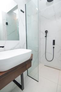 a bathroom with a sink and a shower at Olea Apartments Palioura Epanomi in Epanomi