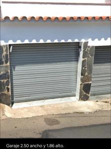 a closed garage door on the side of a building at Apartamento Canyelles playa in Roses