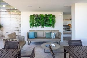 a living room with a couch and chairs and tables at Lobie Casa Mauá in Rio de Janeiro