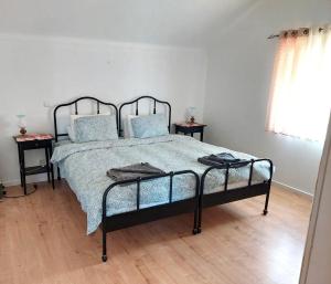 a bedroom with a bed with blue pillows at Casa Alegria - Apartment Vista da Serra in Tomar