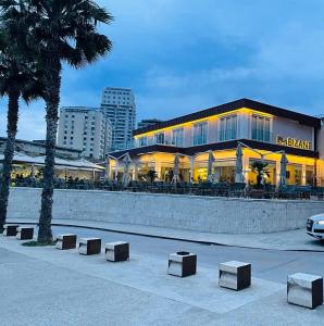 een gebouw met banken ervoor bij Bizant Boutique Hotel & Coffee,Bar in Durrës