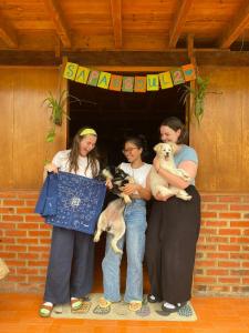 a group of three women standing with a dog at Sapa's soul hillside in Sa Pa